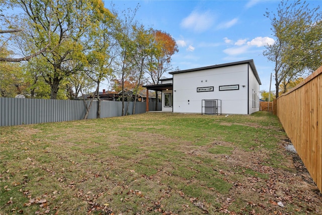 rear view of property with a yard