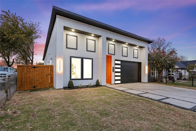 contemporary house with a garage and a yard