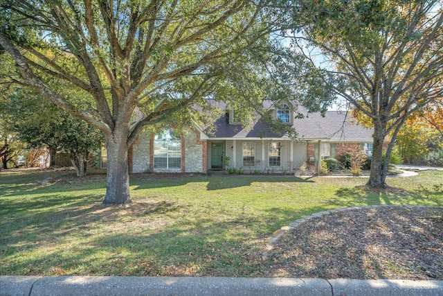 cape cod-style house with a front lawn