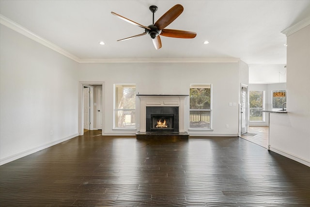 unfurnished living room featuring dark hardwood / wood-style flooring, crown molding, a high end fireplace, and ceiling fan