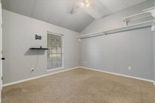 carpeted spare room with ceiling fan and lofted ceiling