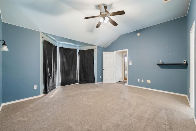 unfurnished bedroom featuring carpet floors, vaulted ceiling, and ceiling fan