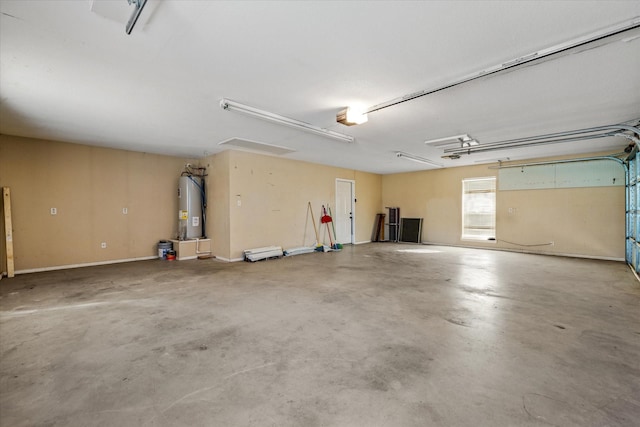 garage featuring a garage door opener and water heater