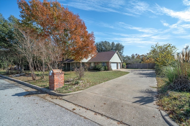 single story home featuring a garage and a front yard