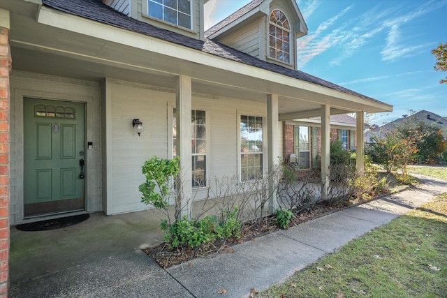 view of exterior entry with a porch