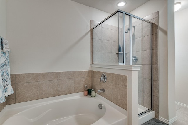 bathroom featuring shower with separate bathtub