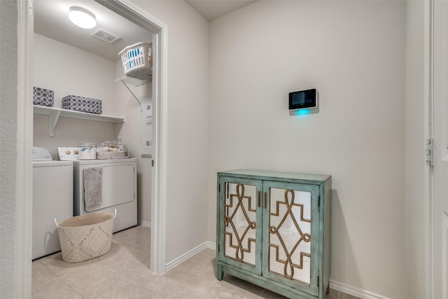 clothes washing area with washing machine and clothes dryer