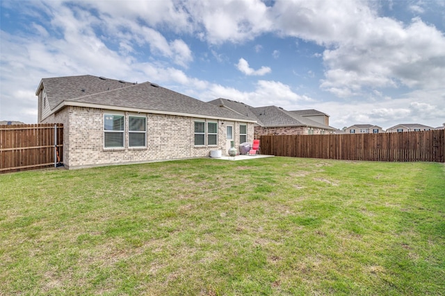 back of property featuring a lawn and a patio