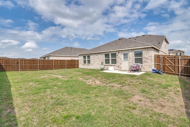 back of house featuring a yard and a patio area