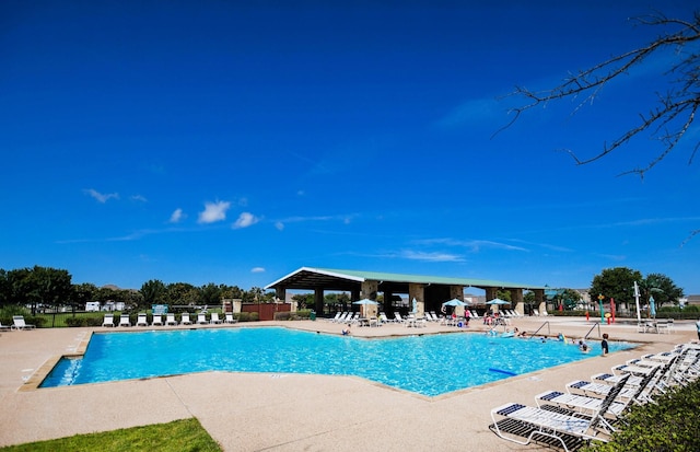 view of swimming pool featuring a patio area