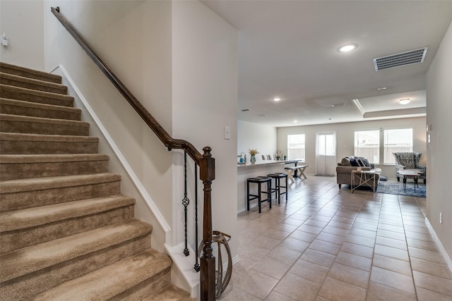 stairway with tile patterned flooring