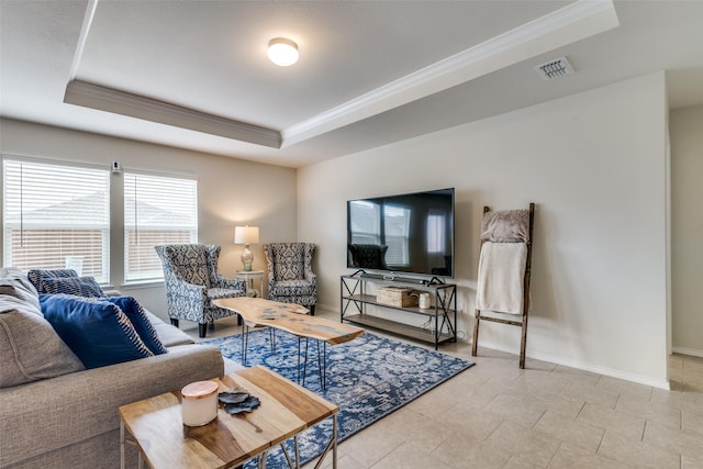 tiled living room with a raised ceiling and crown molding