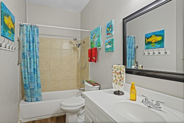9601 Forest Ln Unit 412, Dallas, TX 75243 - full bath with shower / bath combination with curtain, wood finished floors, vanity, and a textured wall