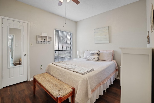 bedroom with ceiling fan, dark hardwood / wood-style flooring, and a textured ceiling