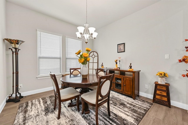 dining room featuring a chandelier and wood-type flooring