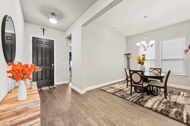 foyer featuring hardwood / wood-style flooring and a notable chandelier