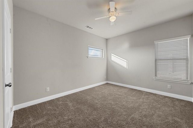 carpeted empty room featuring ceiling fan