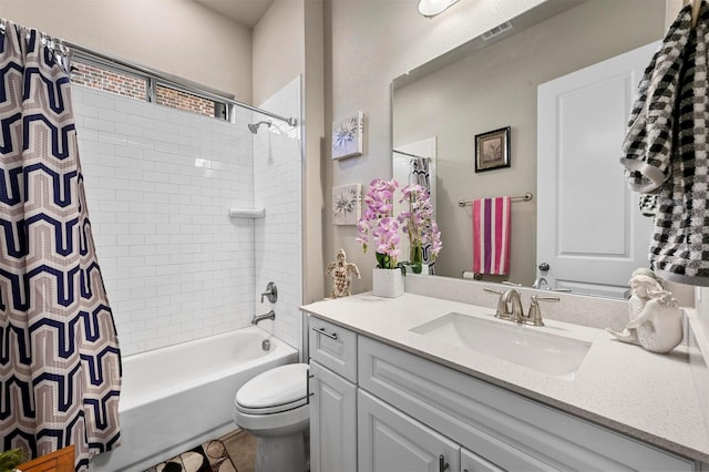 full bathroom with vanity, shower / bath combination with curtain, and toilet