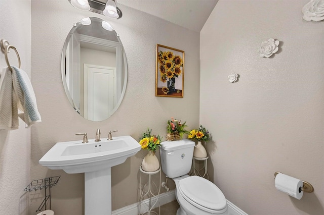 bathroom featuring toilet and lofted ceiling