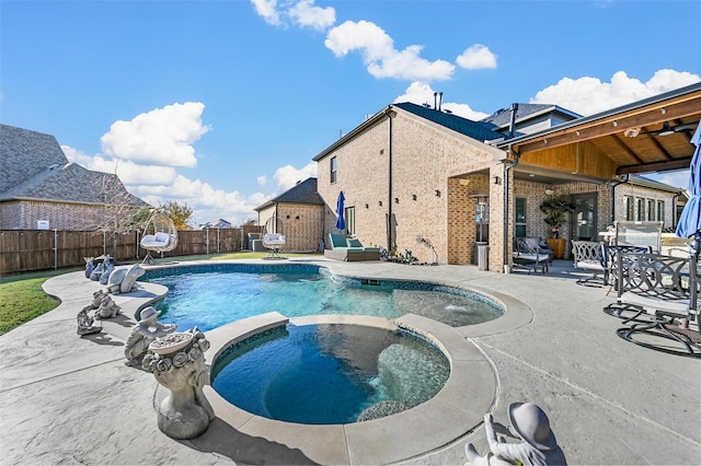 view of swimming pool featuring a patio area and an in ground hot tub