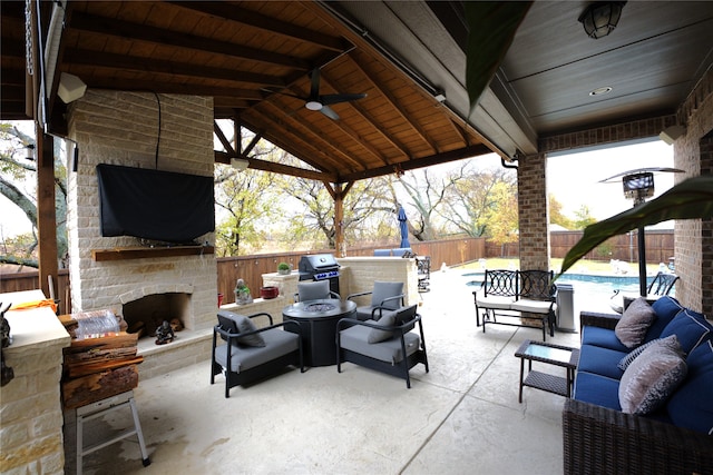 view of patio / terrace with an outdoor living space with a fireplace, a fenced in pool, and ceiling fan