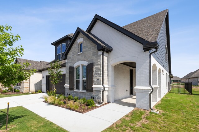 french country inspired facade with a front lawn