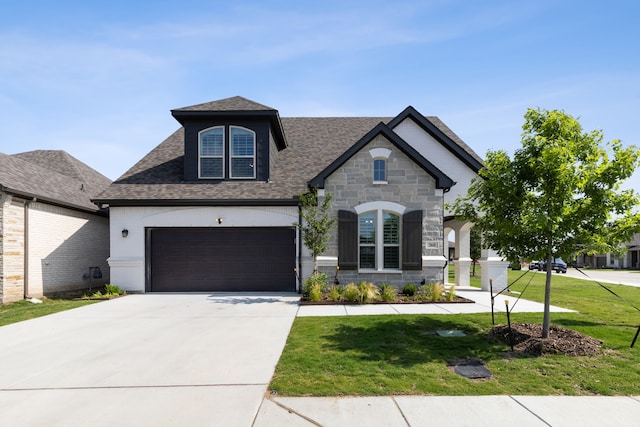 view of front facade featuring a garage and a front lawn