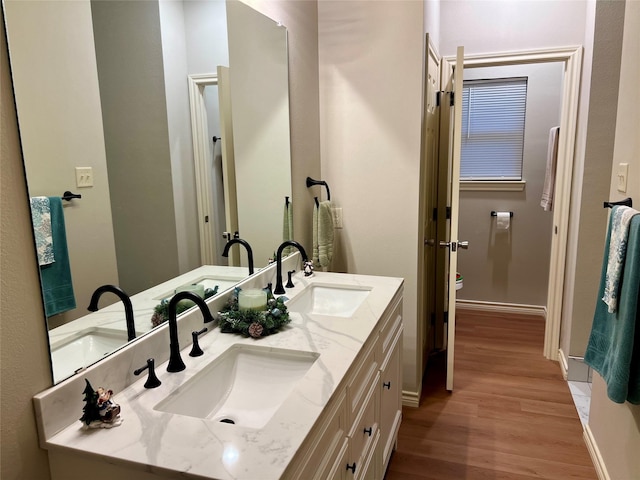 bathroom featuring hardwood / wood-style flooring and vanity