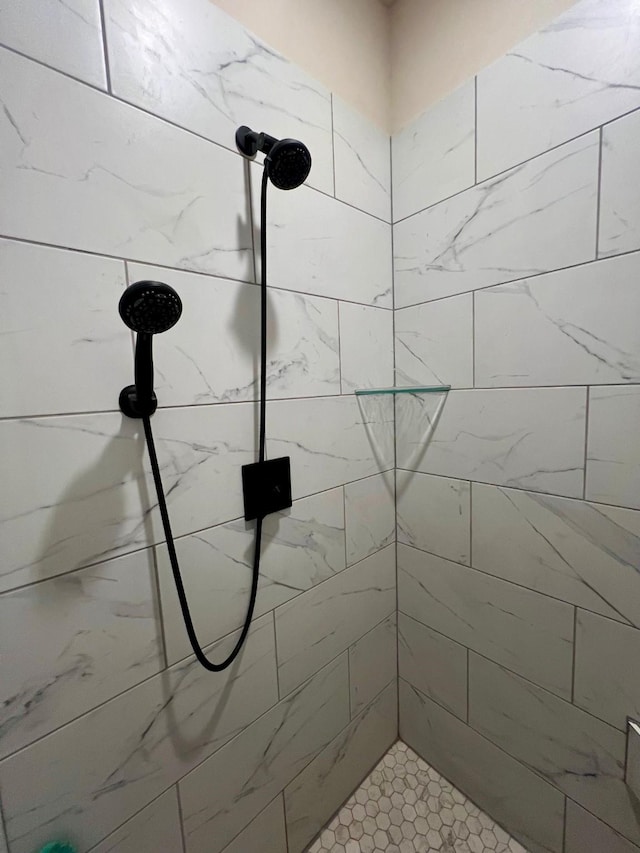 bathroom with a tile shower