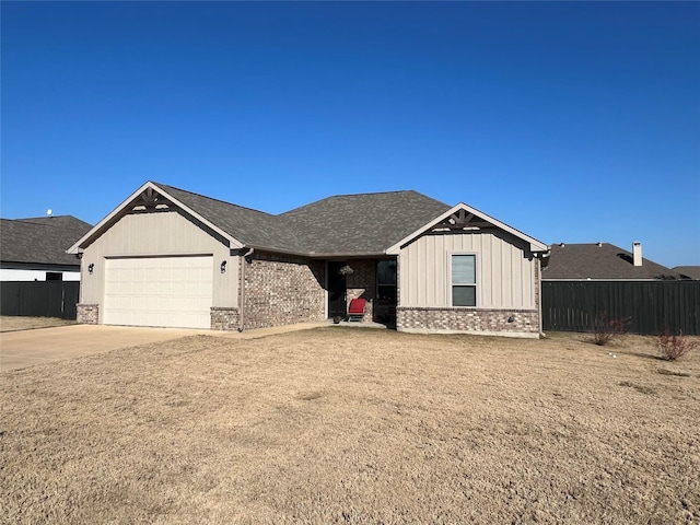 view of front of home featuring driveway, a shingled roof, an attached garage, fence, and brick siding