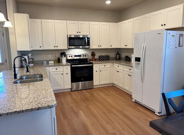 kitchen with ceiling fan with notable chandelier, light stone countertops, white cabinets, dishwasher, and sink