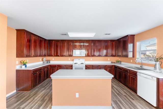 kitchen featuring a kitchen island, white appliances, sink, and light hardwood / wood-style flooring