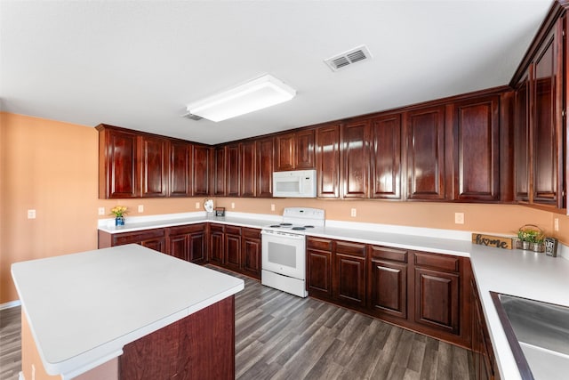 kitchen with a kitchen island, dark hardwood / wood-style flooring, white appliances, and sink