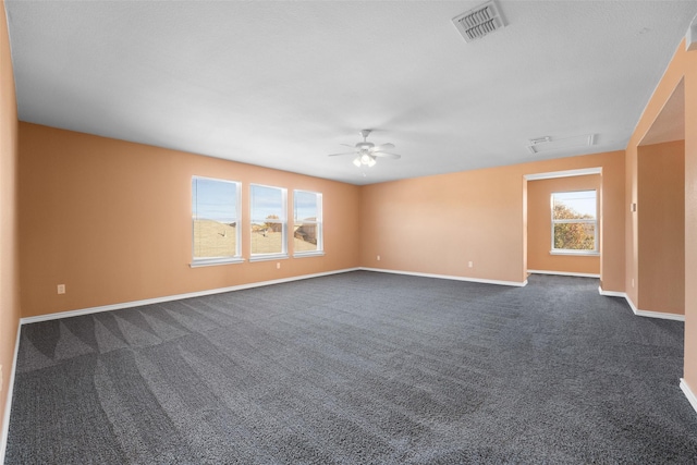 carpeted spare room featuring ceiling fan