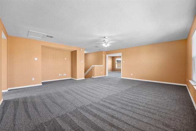 unfurnished room with dark colored carpet and ceiling fan