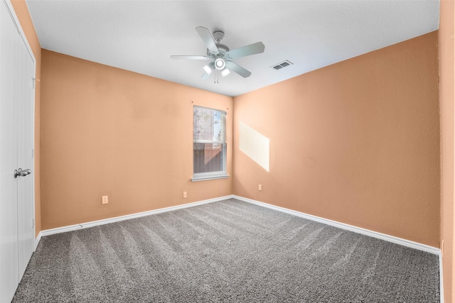 spare room featuring ceiling fan and carpet