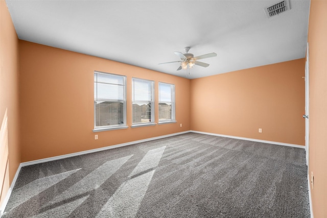 carpeted spare room featuring ceiling fan