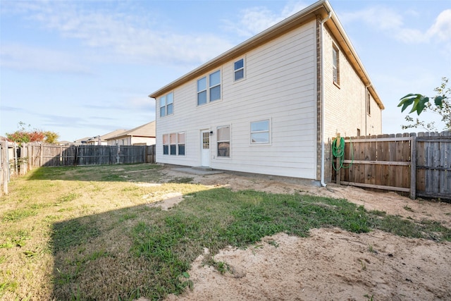 back of house with a yard