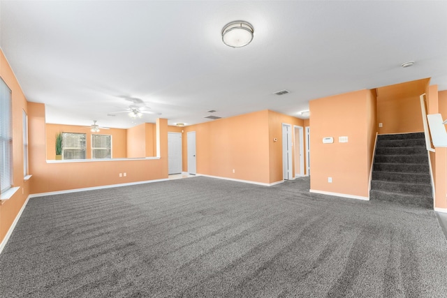 carpeted empty room featuring ceiling fan