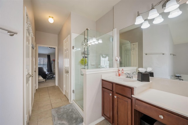 bathroom featuring tile patterned floors, vanity, and a shower with door