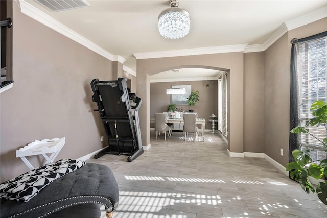 exercise area featuring light tile patterned floors, crown molding, and a chandelier