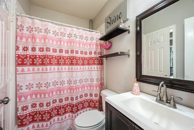 bathroom featuring vanity, toilet, and walk in shower