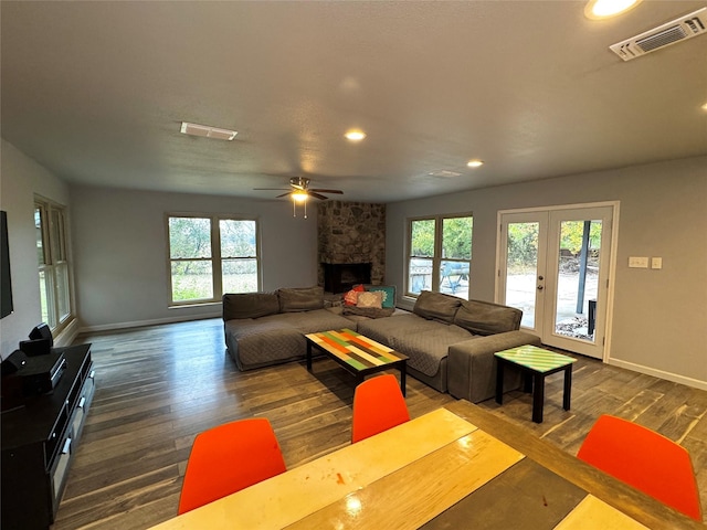 living room with dark wood-type flooring, a wealth of natural light, and french doors