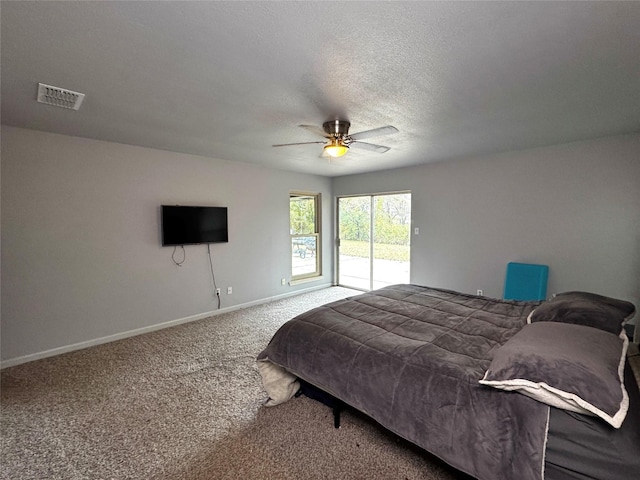 carpeted bedroom with ceiling fan, a textured ceiling, and access to outside