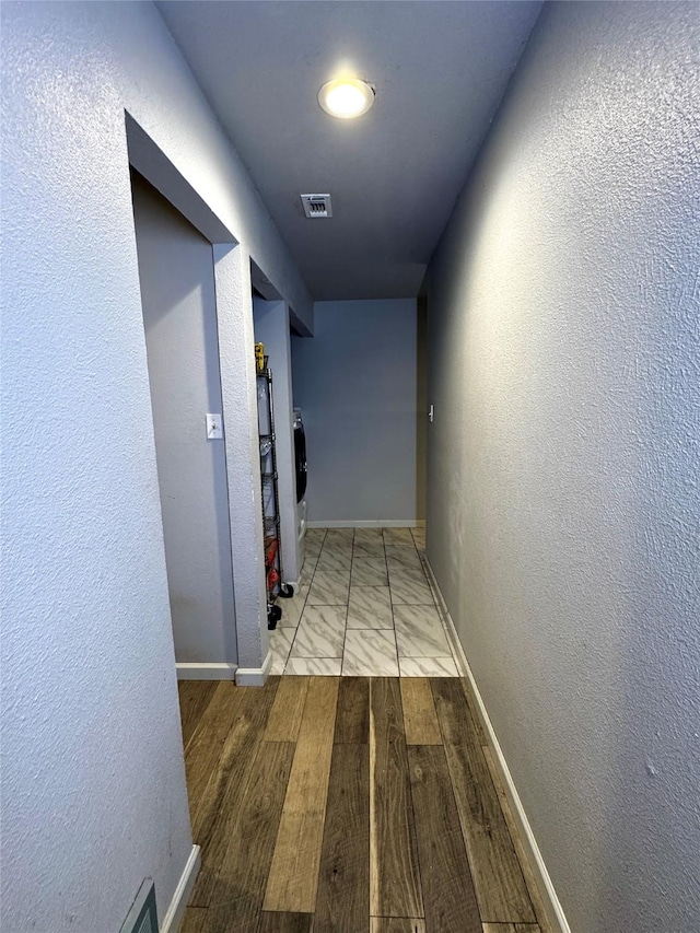 corridor with light wood-type flooring