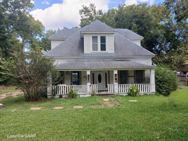 view of front facade featuring covered porch, a front lawn, and a shingled roof