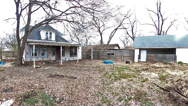 exterior space featuring a shingled roof and fence