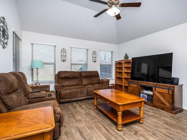 living room with ceiling fan, high vaulted ceiling, and hardwood / wood-style flooring