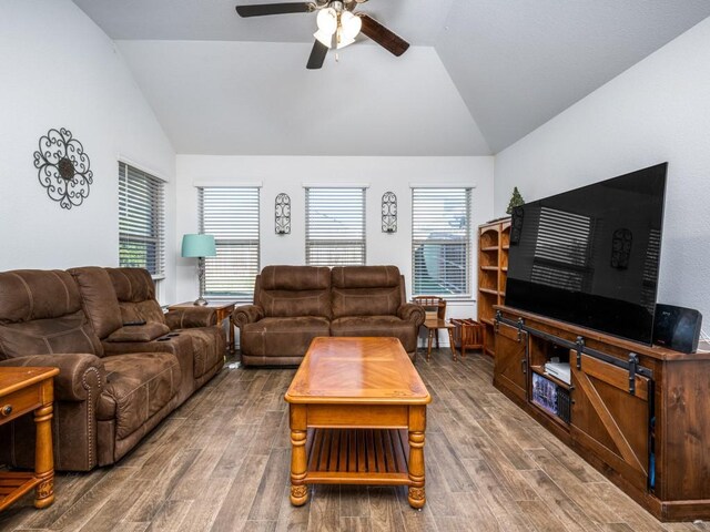 living room featuring hardwood / wood-style floors, ceiling fan, and vaulted ceiling