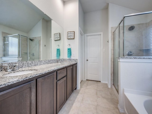 bathroom featuring tile patterned flooring, shower with separate bathtub, lofted ceiling, and vanity